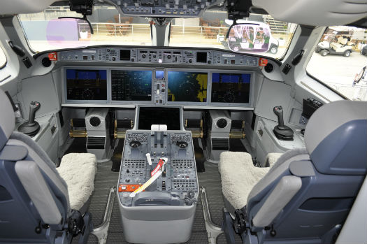 THe CS100 cockpit features four large flat panel displays and fly-by-wire sidestick controllers.