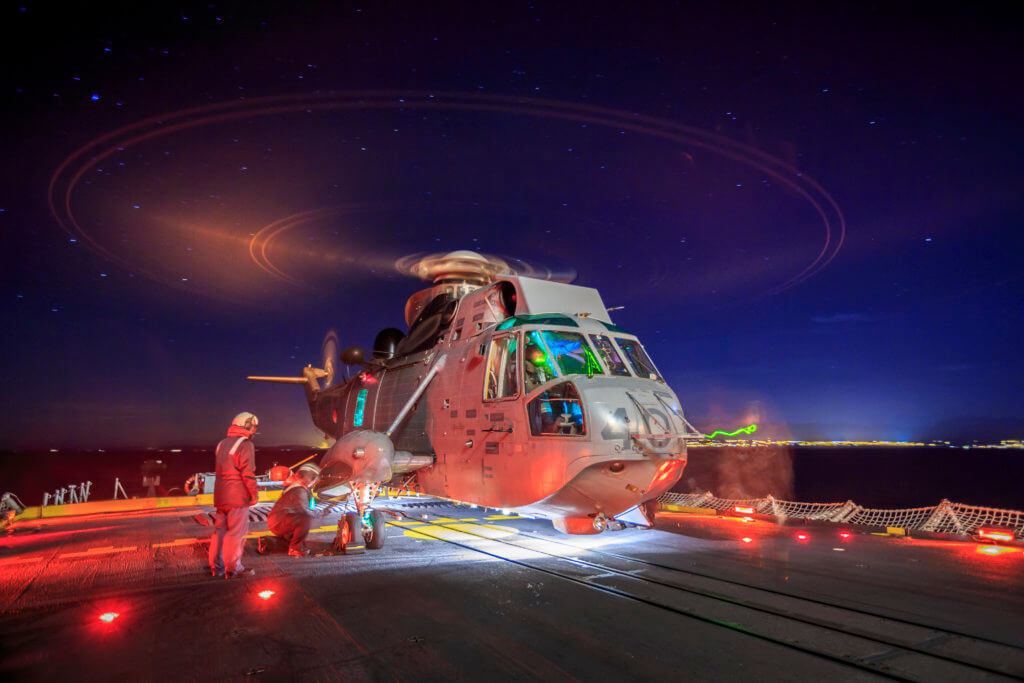 A CH-124 Sea King from 443 Squadron conducts ship-based training and night qualifications onboard HMCS Vancouver off the coast of Vancouver Island.