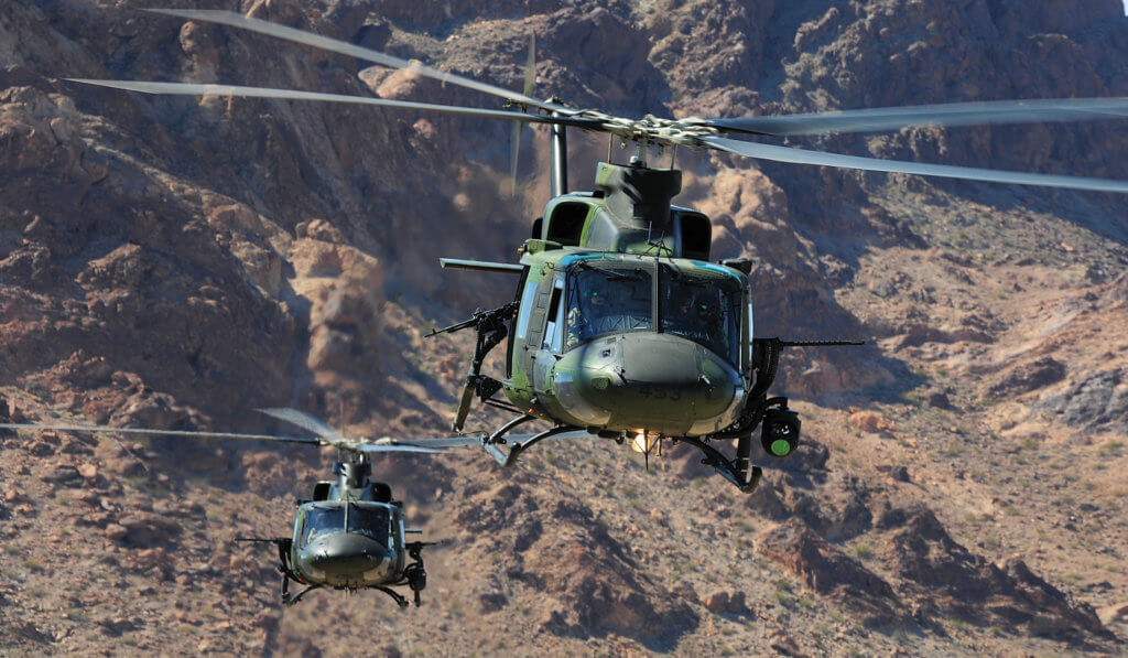 Two Bell CH-146s fly out of the Chocolate Mountain military gunnery range. 
