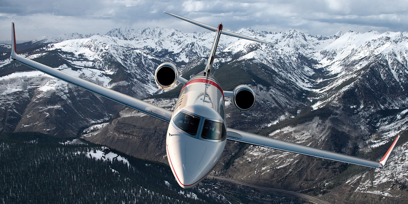Flying Learjet aircraft in the cloudy sky