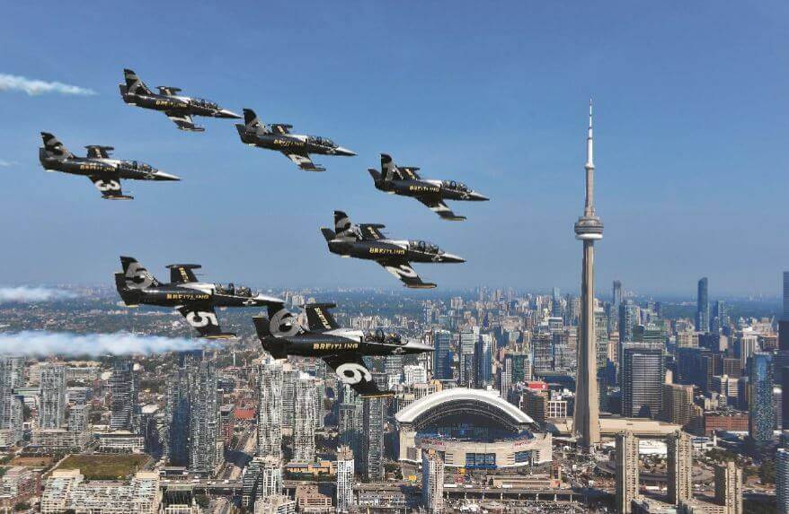 The Breitling Jet Team flew its seven L-39C Albatros jets at speeds up to 700 kilometres per hour, within just a few feet from each other, inspiring fans across North America. Here, the team flies over downtown Toronto. Breitling Photos