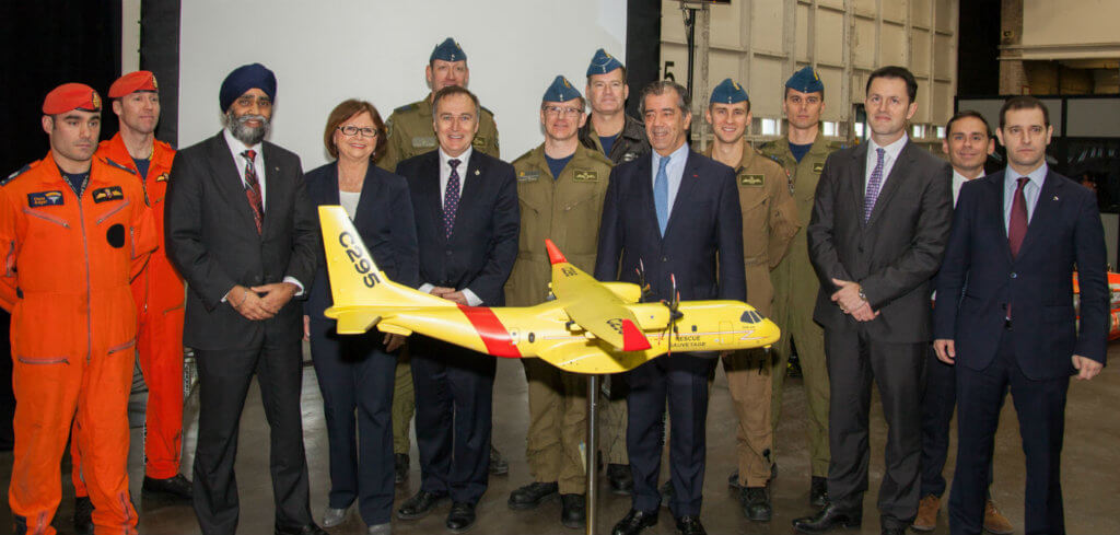 Representatives from the RCAF, the Canadian government and Airbus Defence and Space gather behind a model of the Airbus C295W at CFB Trenton on Dec. 8, 2016. Canada will receive 16 of the aircraft in a search and rescue configuration, with the first to be delivered in three years. Andy Cline Photo