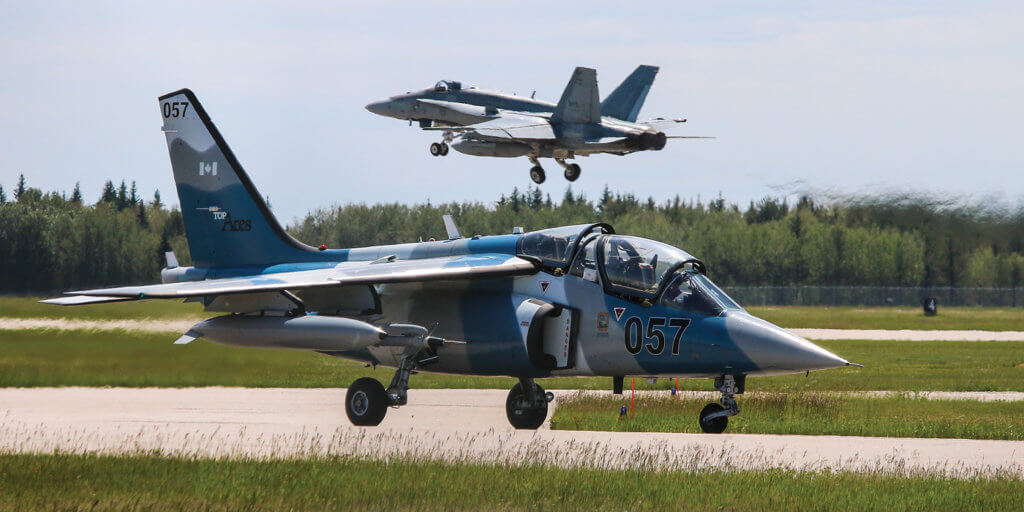 A Discovery Air Defence Alpha Jet taxis out for a training mission while a CF-188 Hornet takes off in the background. Steve Bigg Photo