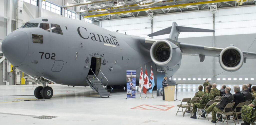 Liberal Member of Parliament Karen McCrimmon marks the opening of the newly-constructed Hangar 6 at 8 Wing Trenton on Jan. 25, 2017. In the background is a CC-177 Globemaster strategic transport aircraft. DND/CAF Photo