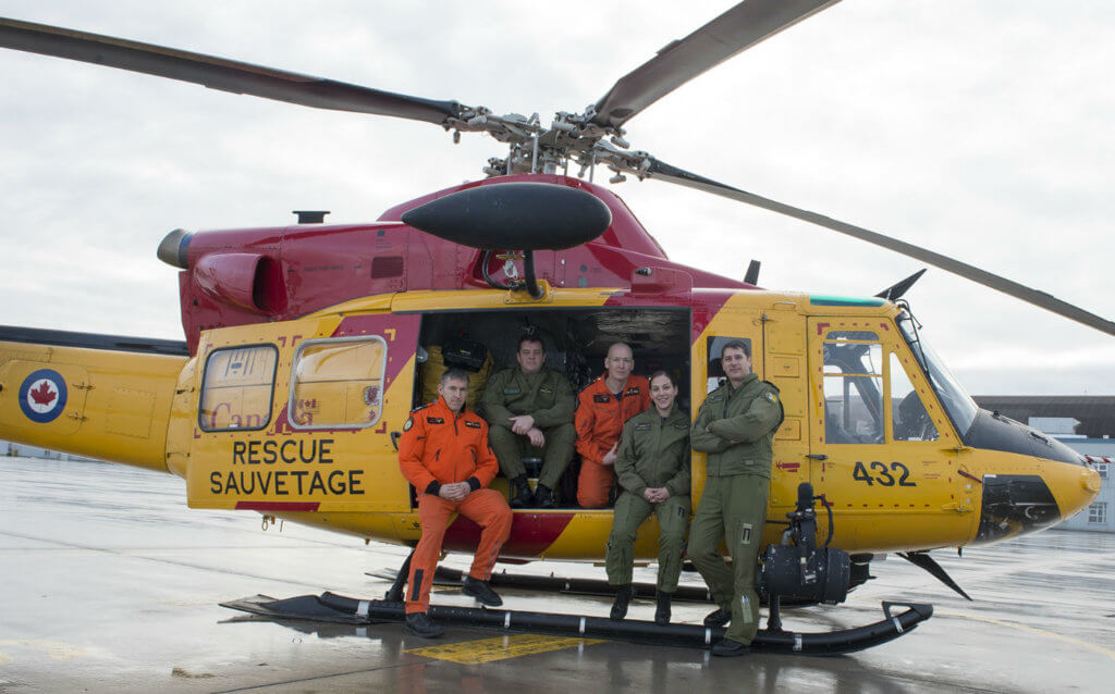 The Griffon crew from 424 Search and Rescue Squadron pose for a photo at Canadian Forces Base Trenton on Jan. 19, 2017. From left: MCpl Jeff Beaudry, SAR technician; MCpl Terry Shanks, flight engineer; Sergeant Cory Cisyk, SAR technician; Capt Stephanie Pouliot, pilot; and Capt Nicholas Bossé, pilot. RCAF Photo