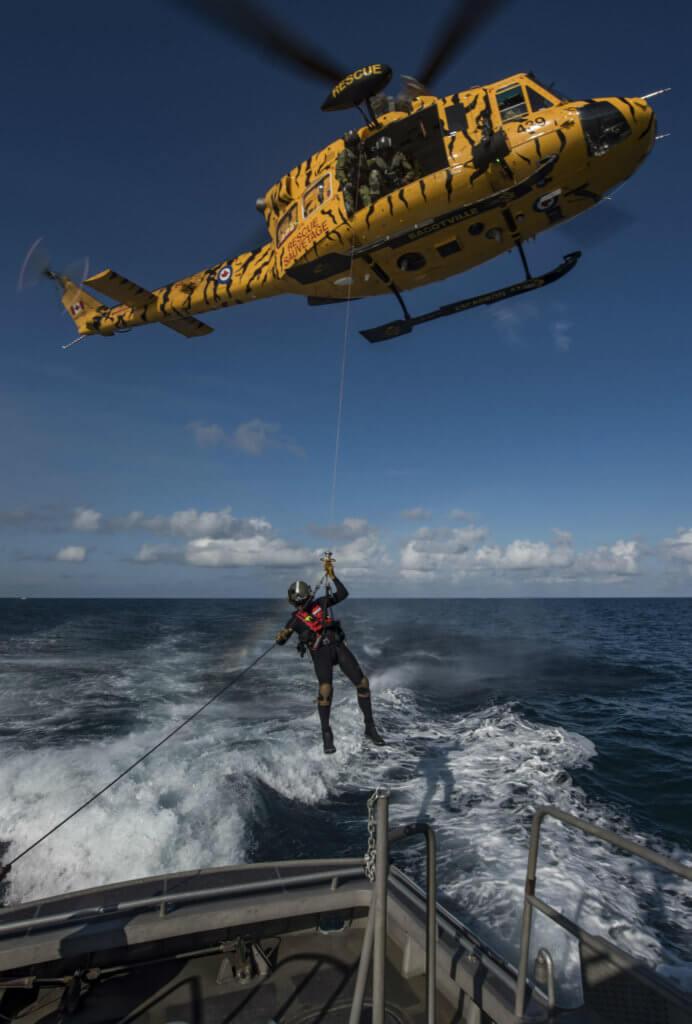 2.A search and rescue technician is lowered from a CH-146 Griffon helicopter onto a simulated vessel in distress off the coast of Miami, Fla., during Exercise SOUTHERN BREEZE on Feb. 7, 2017. Cpl Bryan Carter Photo