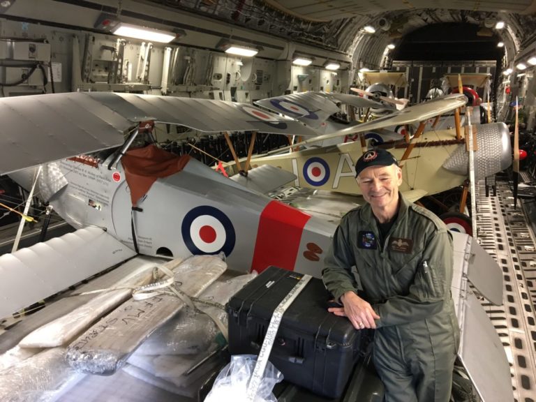 Allan Snowie, team lead for Vimy Flight, stands with several replica aircraft inside the CC-177 Globemaster.