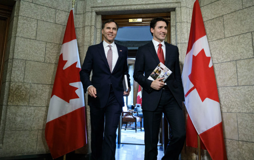 Finance Minister Bill Morneau (left) and Prime Minister Justin Trudeau leaving the Prime Minister's Office (PMO) in Ottawa on March 21, 2017. PMO Photo