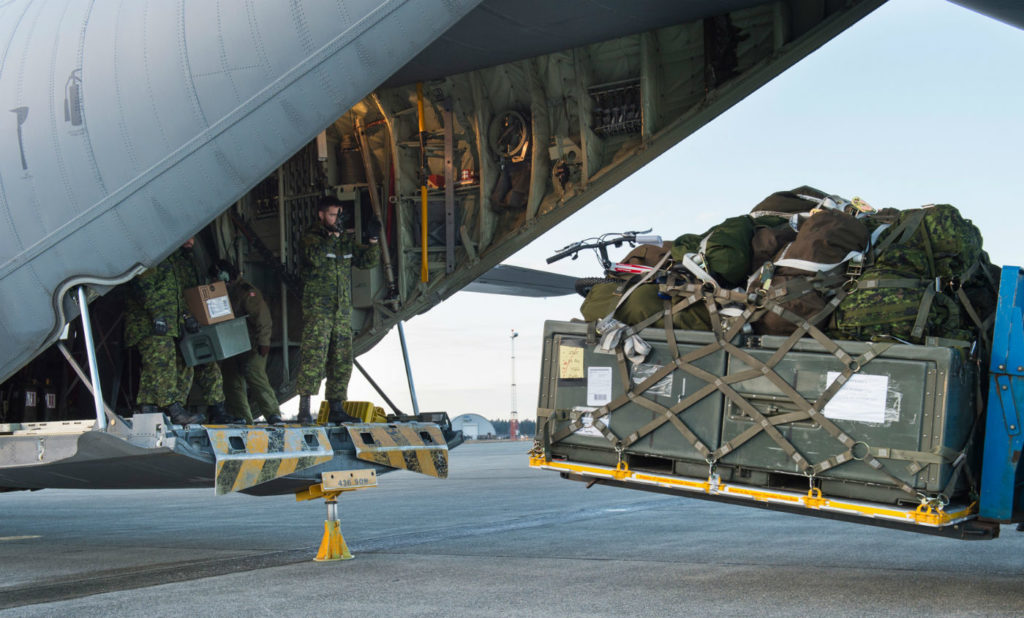 Personnel from 2 Wing Bagotville, Que., unload the equipment required to set up a camp and air operation centre tailored for humanitarian disaster assistance relief missions during Exercise Ready Renaissance. Sgt Halina Folfas Photo