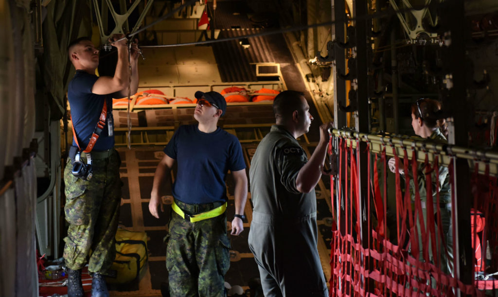 RCAF aircraft maintenance technicians from 436 Transport Squadron secure a static line before a CC-130J Hercules flight on Feb. 10, 2017, at Little Rock Air Force Base in Arkansas. The RCAF was preparing to airdrop U.S. Army personnel from the 509th Infantry Regiment for a mission during Green Flag Little Rock 17-04. USAF Photo