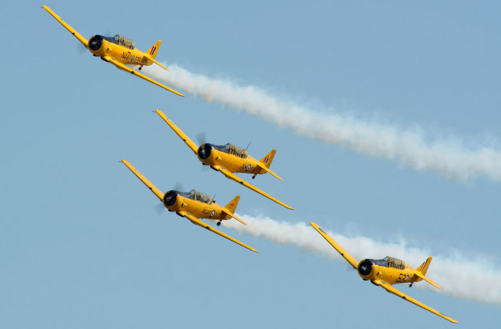 Painted yellow in their Royal Canadian Air Force markings, the Harvards never fail to attract attention. Billowing trails of white smoke, the growl of the Pratt and Whitney R-1340 radial engine and a well-choreographed routine have made CHAT a popular airshow act. Eric Dumigan Photo