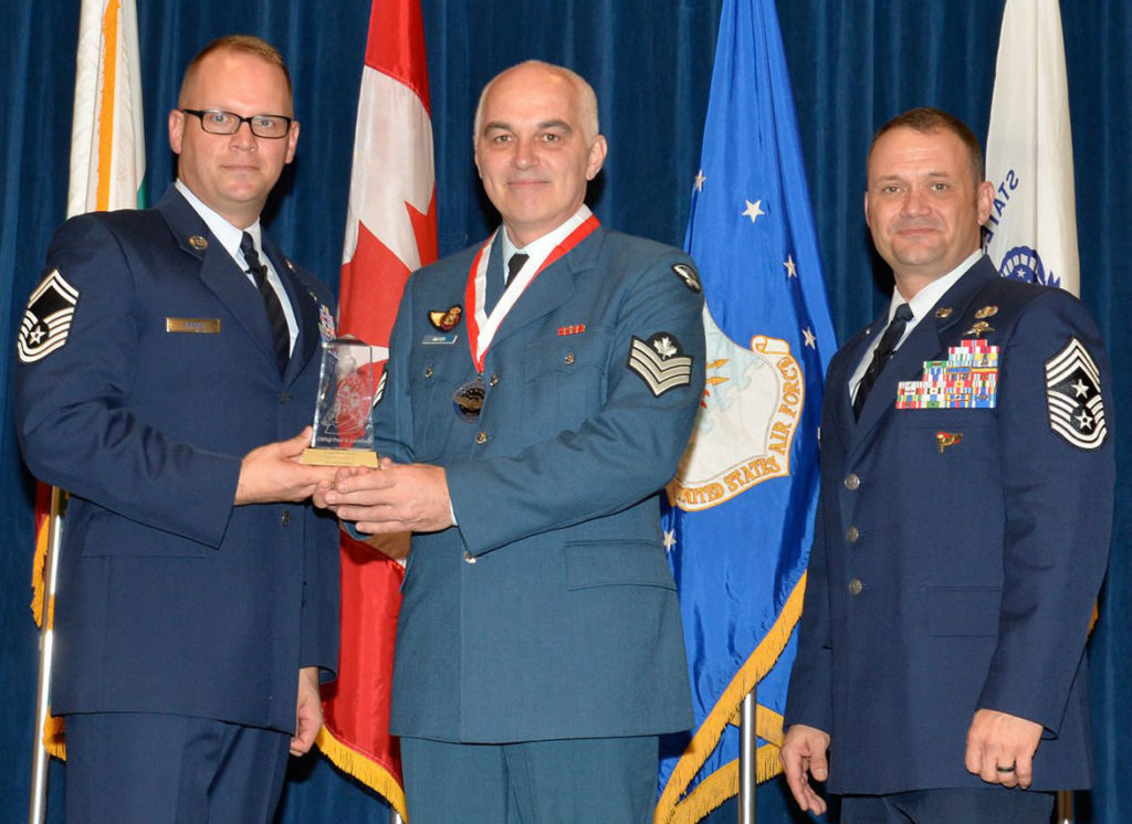 Sgt Jocelyn Mayer, a reservist from 438 Tactical Helicopter Squadron, receives the Commandant Leadership Award at I.G. Brown Training and Education Center, on March 28, 2017. From left: Senior Master Sgt Nicholas Brock, director of education at the Paul H. Lankford Enlisted Professional Military Education Center; Mayer; and Chief Master Sgt Shane Wagner, command chief master sergeant of the 4th Fighter Wing. Master Sgt Jerry D. Harlan Photo