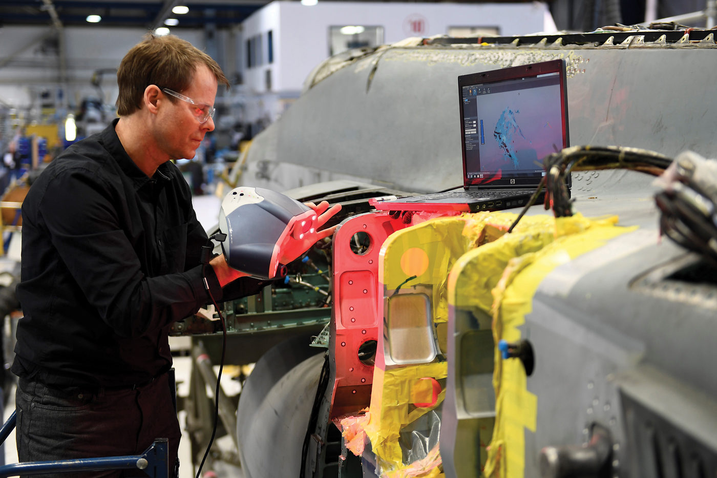 An employee performs 3D scanning on aircraft components at L3 MAS in Mirabel, Que. L3 MAS Photo