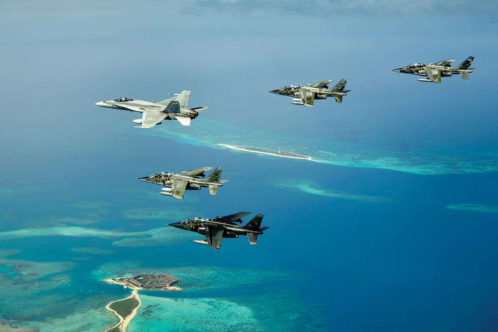 A CF-188 Hornet is accompanied by four DA Defence Alpha Jets during an international training exercise over Fort Jefferson in the lower Florida Keys.