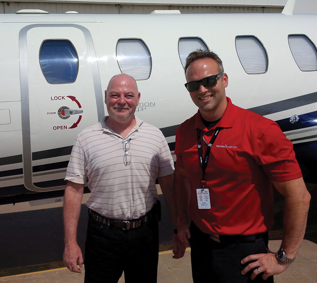 Rob Erdos, left, with Textron demonstration pilot Ken Mullins in front of the CJ3+ in Wichita.