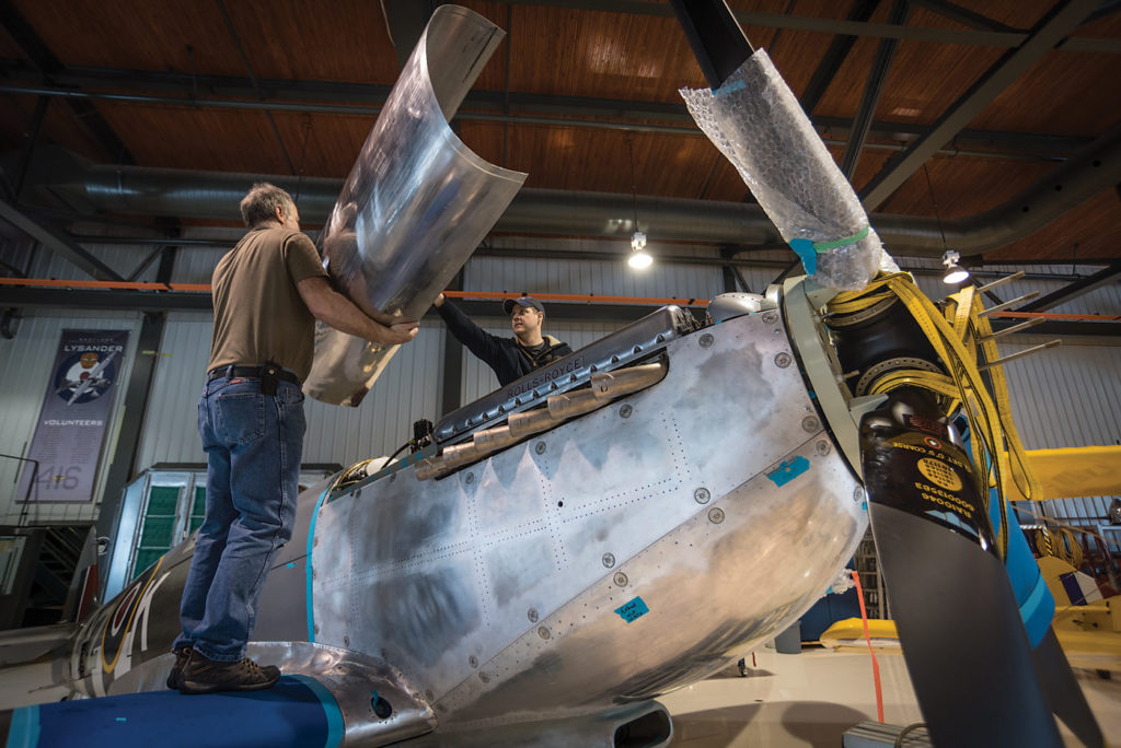 Aircraft structures engineer Ken Wood (left) and mechanic Pat Tenger of Vintech Aero test fit an engine cowling on the Roseland Spitfire Mk IV. The project, which got its start in Comox, B.C., is now finished and the aircraft will undergo engine and initial flying tests at Gatineau. Peter Handley Photo