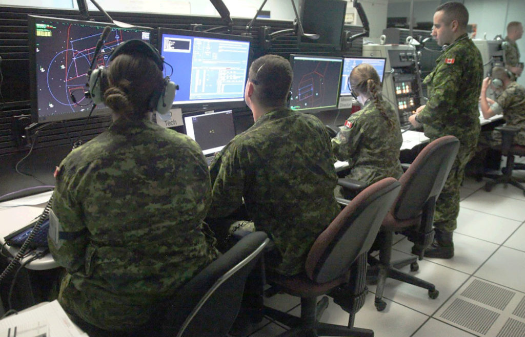 Royal Canadian Air Force air battle managers with 42 Radar Squadron, 4 Wing Cold Lake, Alta., and United States Marine Corps tactical air defence controllers with Marine Air Control Squadron 2, work together on May 31, 2017, to prepare for the launch of the morning wave of Exercise Maple Flag 50 at 4 Wing. 2nd Lt Stephanie Leguizamon Photo