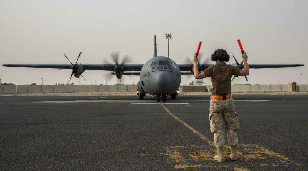 A technician guides a CC-130J Hercules as it returns from its first mission with Operation IMPACT in Kuwait, Iraq, on July 12, 2017. Op IMPACT Imaging