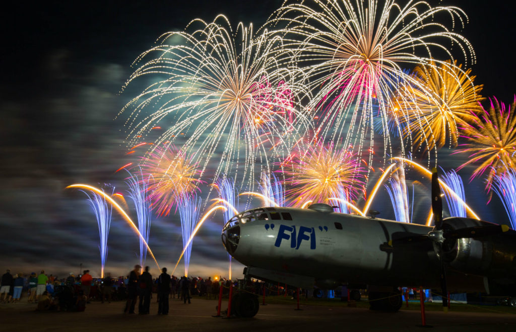 A newly restored Boeing B-29 sits on the tarmac during a beautiful firework display. Warren Liebmann Photo