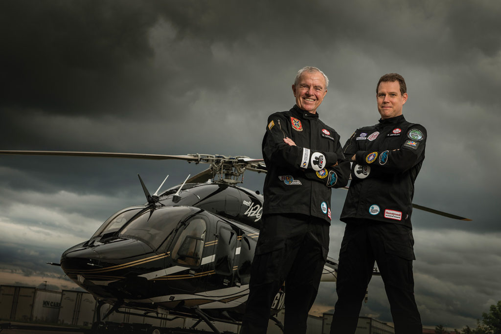 Bob, left, and Steven Dengler stand with the Bell 429 helicopter they used to circumnavigate the globe.