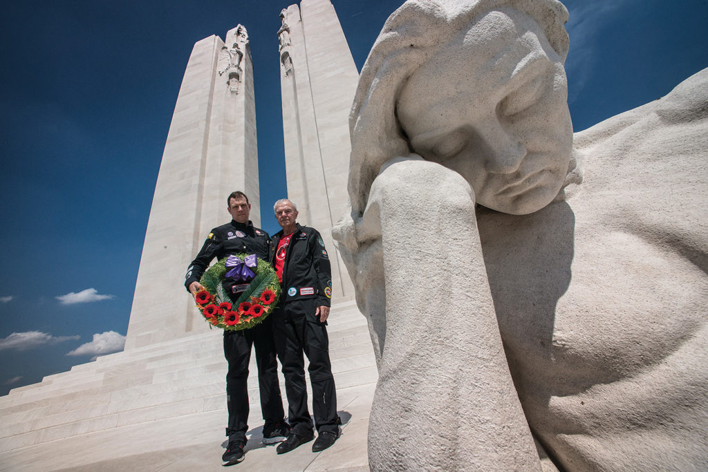 Steven Dengler, left, and his father Bob Dengler carry a wreath at the Canadian National Vimy Memorial in France in the summer of 2017.