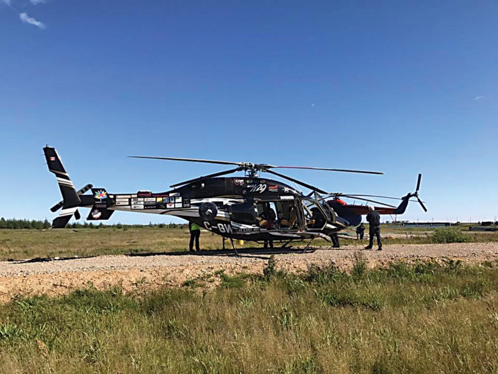 The helicopter rests on the ground in Magadan, Russia.