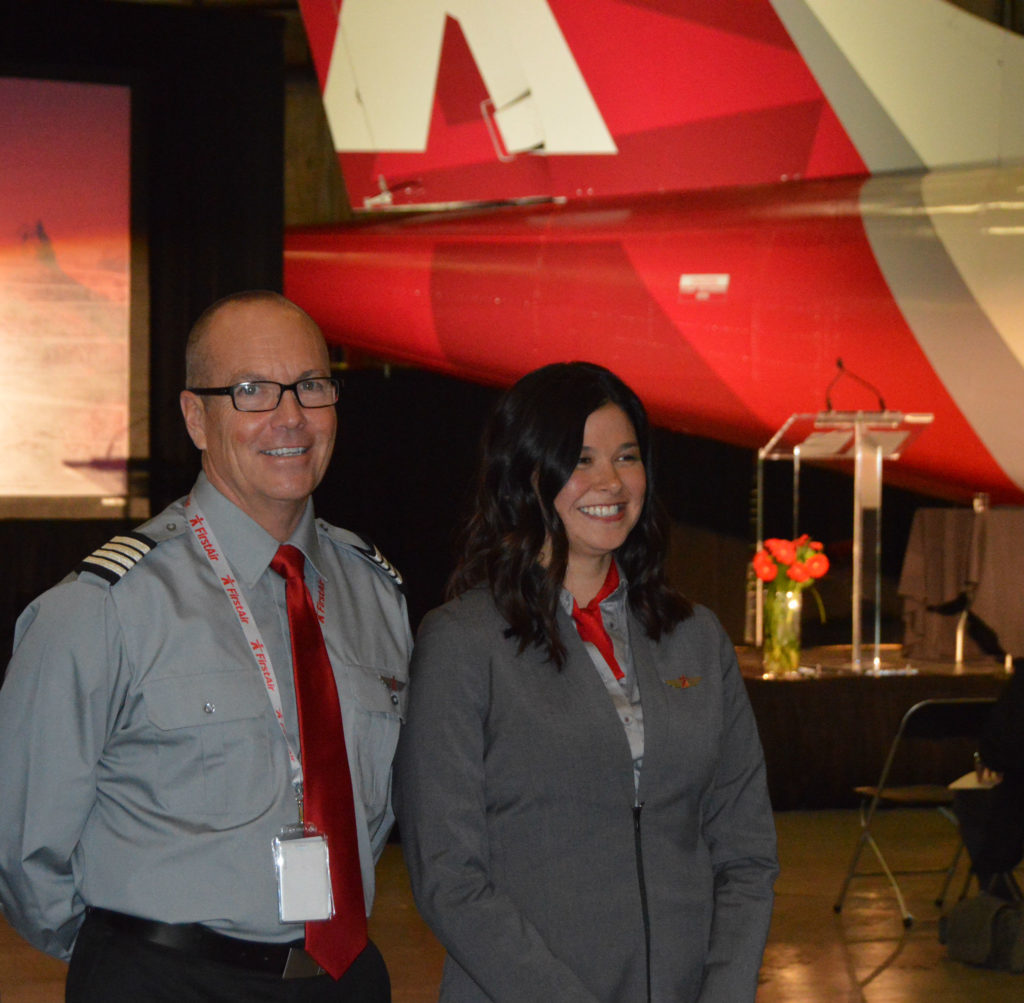 Stephan Ekiert, chief pilot on First Air's flagship Boeing 737-400, helps to model the new uniforms which are a key element of the carrier's major rebranding project. He is flanked by Kuujjuaq sales manager, Shelly De Caria. Ken Pole Photo