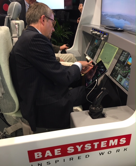 Adam Taylor of BAE Systems demonstrating the use of active control side sticks at NBAA-BACE. Lisa Gordon Photo