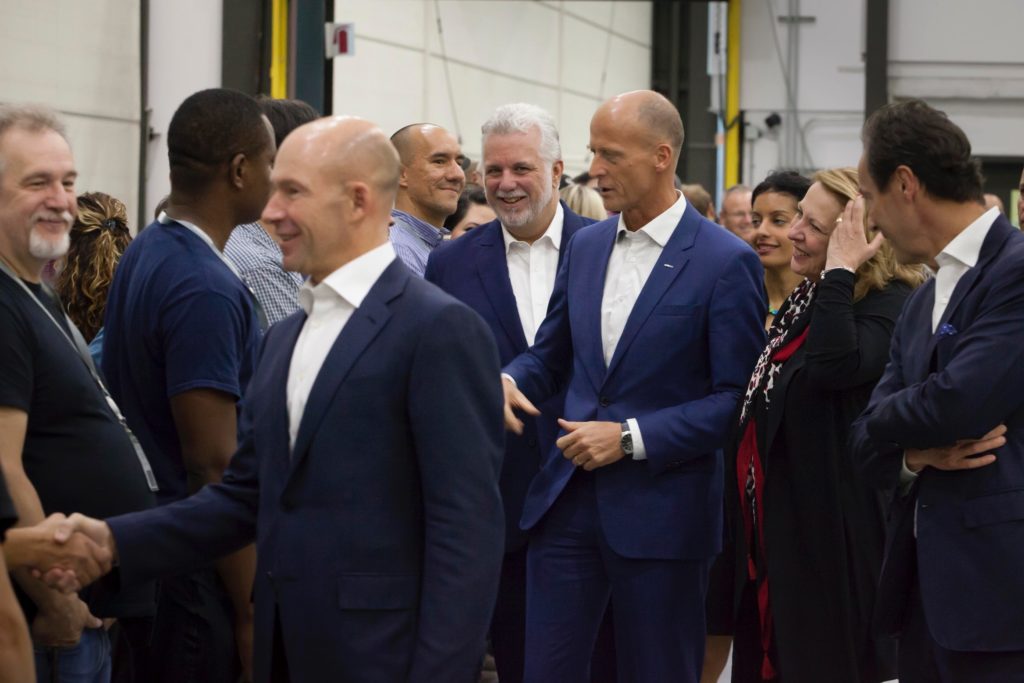 Bombardier's chief executive officer, Alain Bellemare (front), greets Bombardier employees in Mirabel, Que. with Quebec Premier, Philippe Couillard (left), and Airbus chief executive officer, Tom Enders (right), following behind him. Bombardier Photo