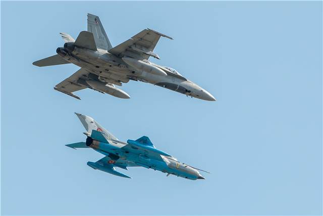 A CF-188 Hornet aircraft, currently deployed on Operation Reassurance in support of NATO enhanced Air Policing, and a Romanian MiG 21 aircraft complete a two-ship flypast at the Romanian 86th Air Force Base open house in Borcea, Romania on Oct. 14, 2017. Sgt Daren Kraus Photo