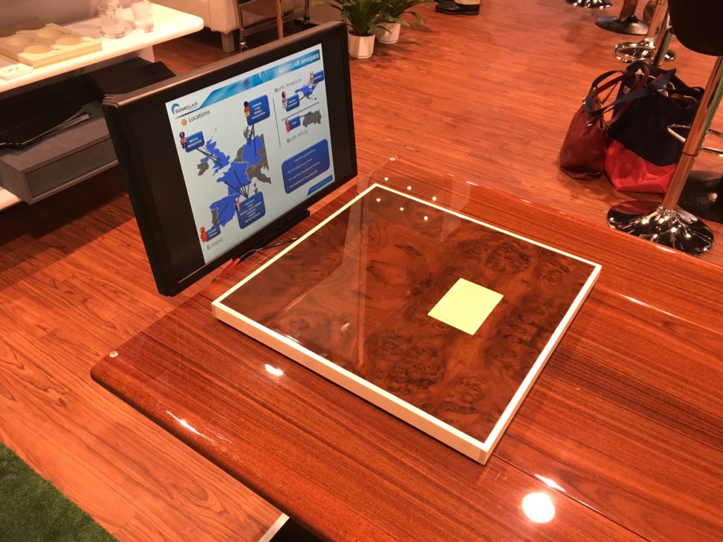 MSB has integrated wireless charging units into their adjustable business jet tables. In this photo, the light-coloured rectangular piece of wood is meant to indicate the location of the charging unit. The company has also come up with a design that mounts a monitor at the end of a table for group presentations. Lisa Gordon Photo