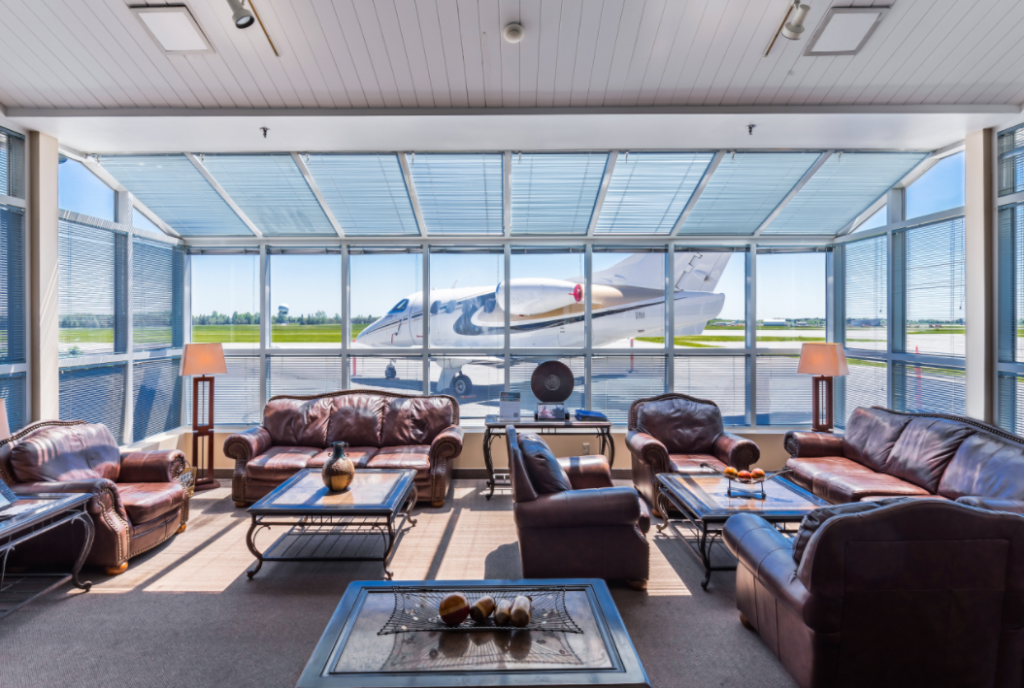 Inside a lounge at Ottawa MacDonald Cartier International Airport, looking out onto a small aircraft on the tarmac.