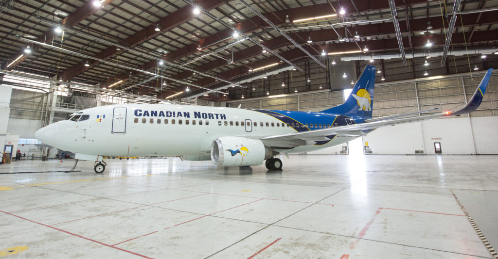 A Canadian North Boeing 737-300 aircraft rests in the main hangar bay at Edmonton International Airport. 