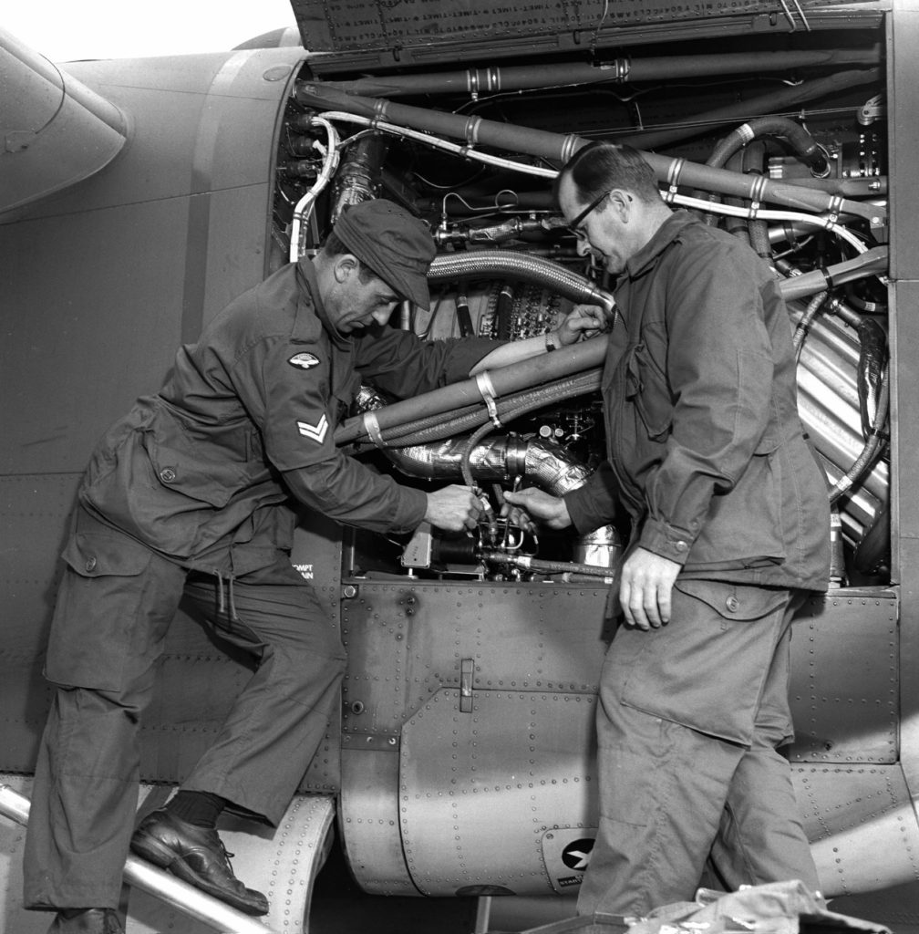 Cpl Andre Brown and Cpl Rolly Hains, both from 429 Squadron, check the engine of a CC-115 Buffalo aircraft on May 15, 1968, during Exercise New Shakedown.
