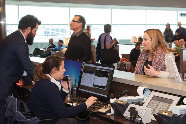 Porter Airlines staff help passengers at Billy Bishop Toronto City Airport.