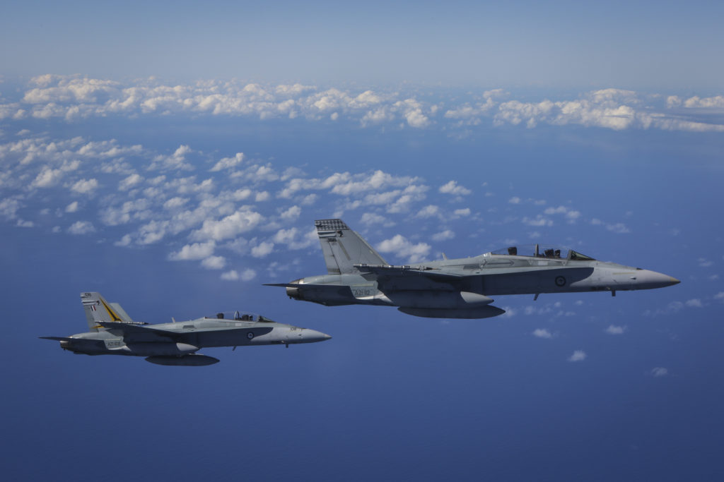 F/A-18B Hornets fly in a formation prior to air-to-air refuelling from a KC-30A Multi-Role Tanker Transport during Exercise Diamond Shield.