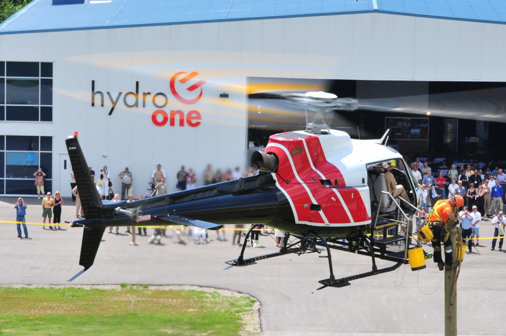 A Hydro One crew demonstrates the use of an external AirStairs platform.
