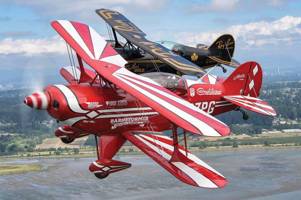 Handy flies in formation with another Pitts S-2B owned by George Kirbyson. It is painted in the original team colours of the Ray-Ban Gold Aerobatic Team.