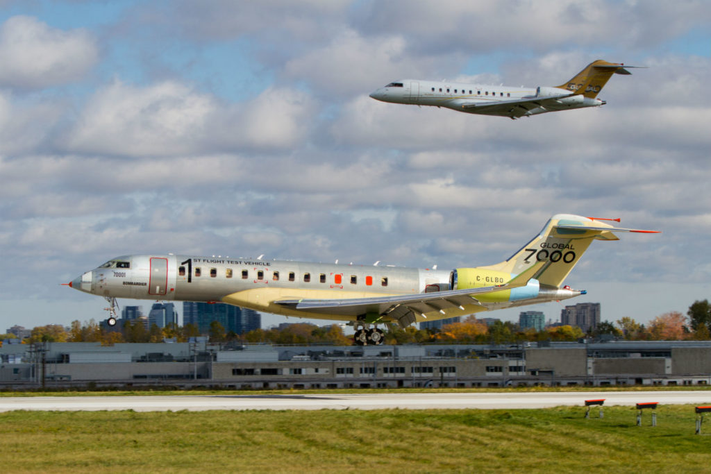 Two business jets, one flying and one on the ground.