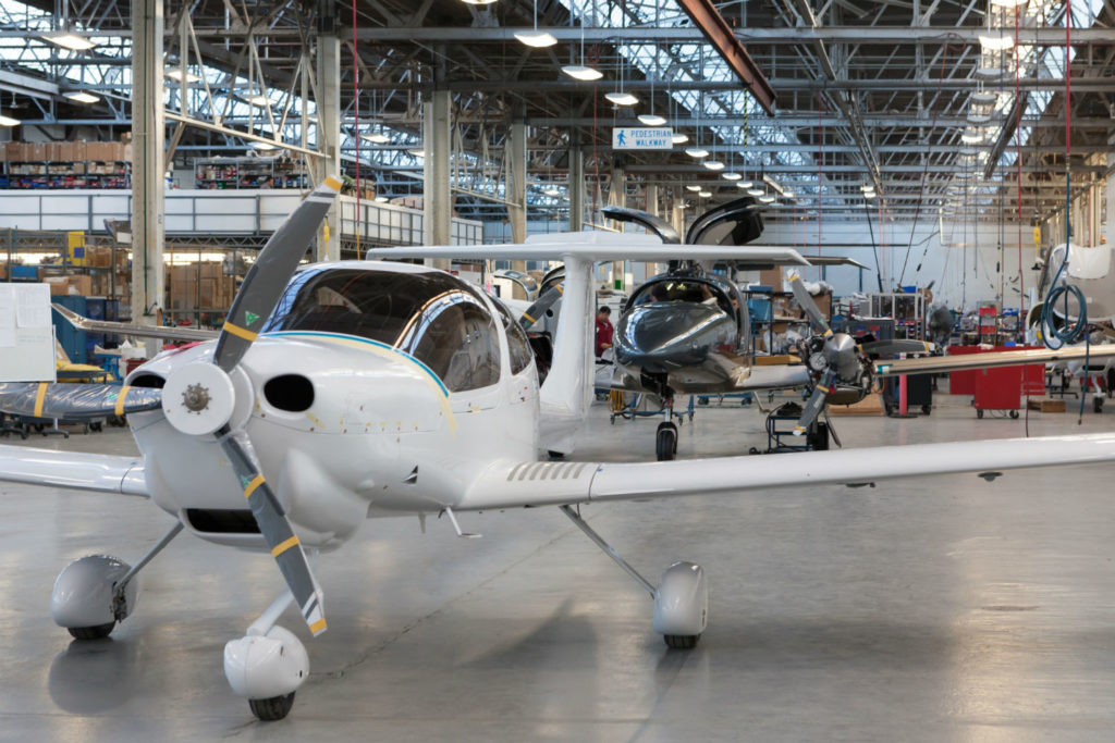A Diamond DA40 (foreground) and DA62 rest on the production line in London, Ont.