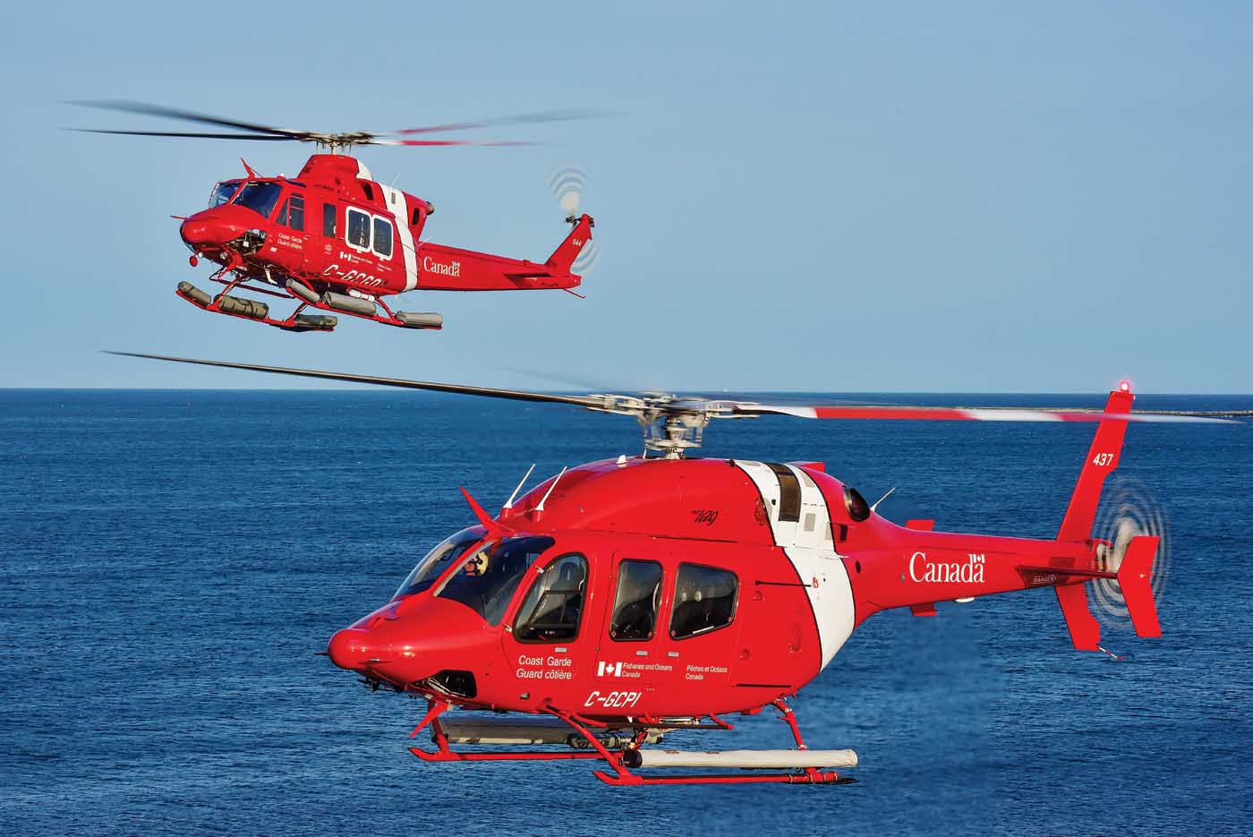 Two coast guard helicopters in flight