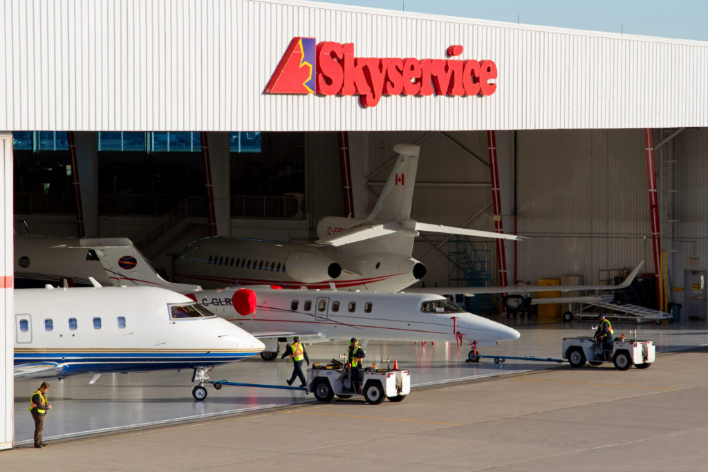 Skyservice hangar with three planes inside.