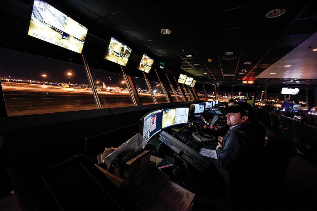 Man sits in darkened control room