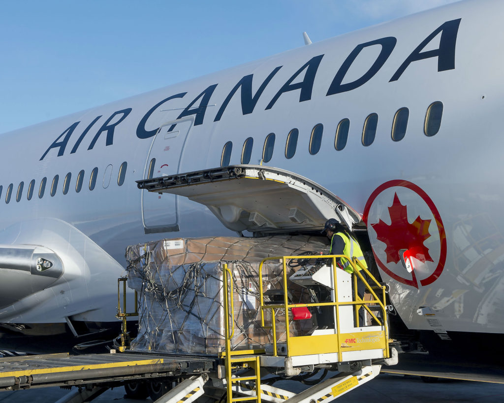 Worker loads cargo into Air Canada jet