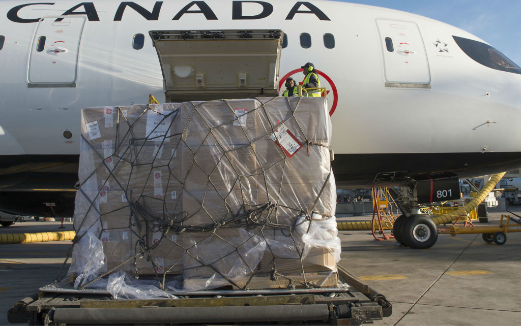 Workers load cargo into Air Canada jet