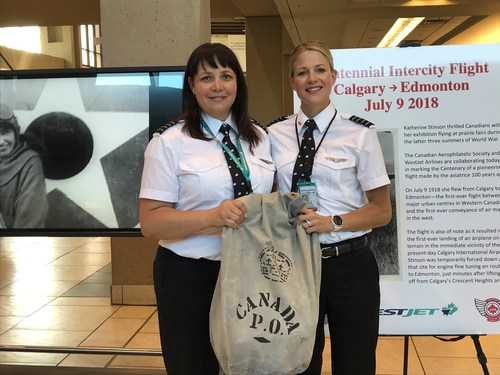 WestJet Encore Captains Athenia Jansen (left) and Janna Breker Kettner (right) stand with an air mail bag for delivery. WestJet Photo