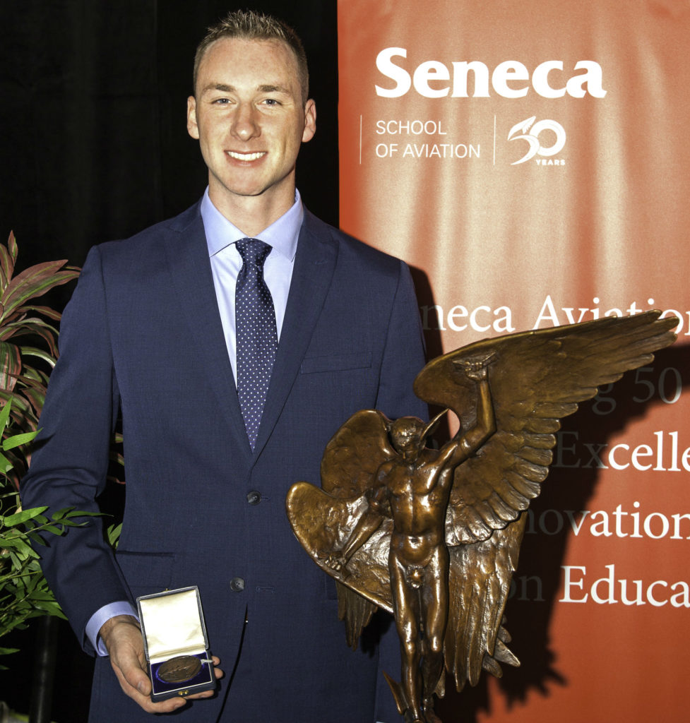 2018 Webster Memorial Trophy winner, Carter Simpson from Seneca College, shows off the trophy and his medallion. Andy Cline Photo
