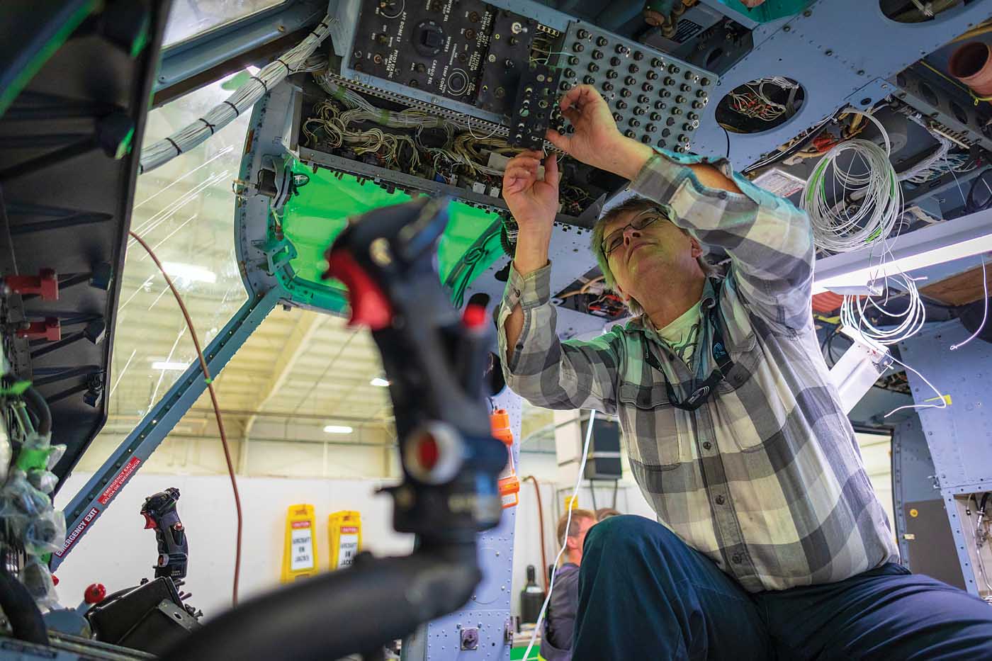 Aeronav Avionics’ aircraft maintenance engineer Brent Butowski works on a wiring bus on a Bell 212 at Victoria International Airport. Heath Moffatt Photo