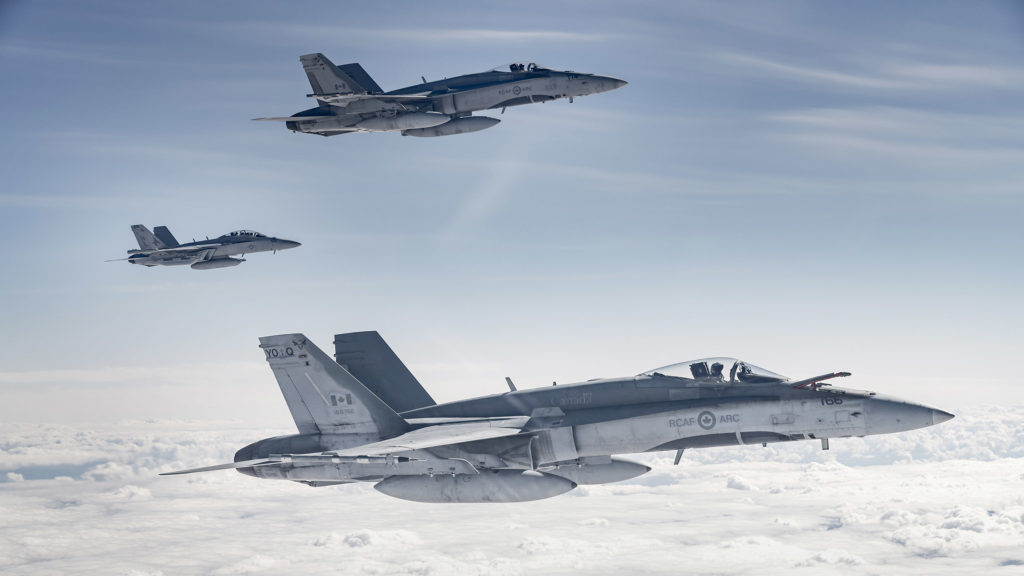 From top to bottom: An RCAF CF-188 Hornet from 425 Tactical Fighter Squadron, a United States Navy EA-18G Growler, and an RCAF CF-188 Hornet from 401 Tactical Fighter Squadron fly the skies over Alberta on June 15, 2018, during Exercise Maple Flag 51.