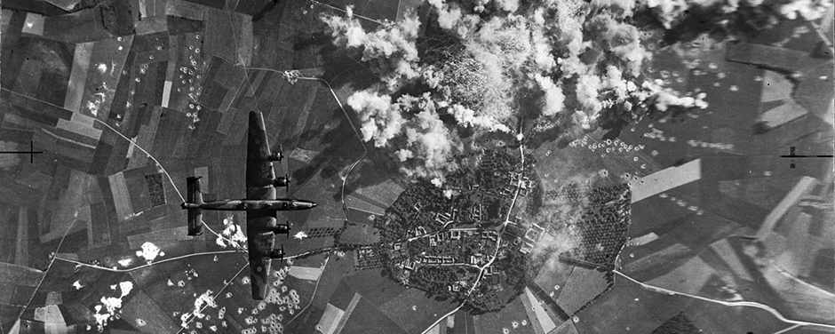 Taken from a Halifax bomber of the Iroquois Squadron, the photo shows smoke rising from a 500-ton bomb attack which was regarded as one of the most successful carried out by Bomber Group's heavy aircraft. Below the Halifax from which the picture was taken is shown another of the large force which pounded the launching site. All around the area can also be seen bomb craters from a previous attack. RCAF Photo